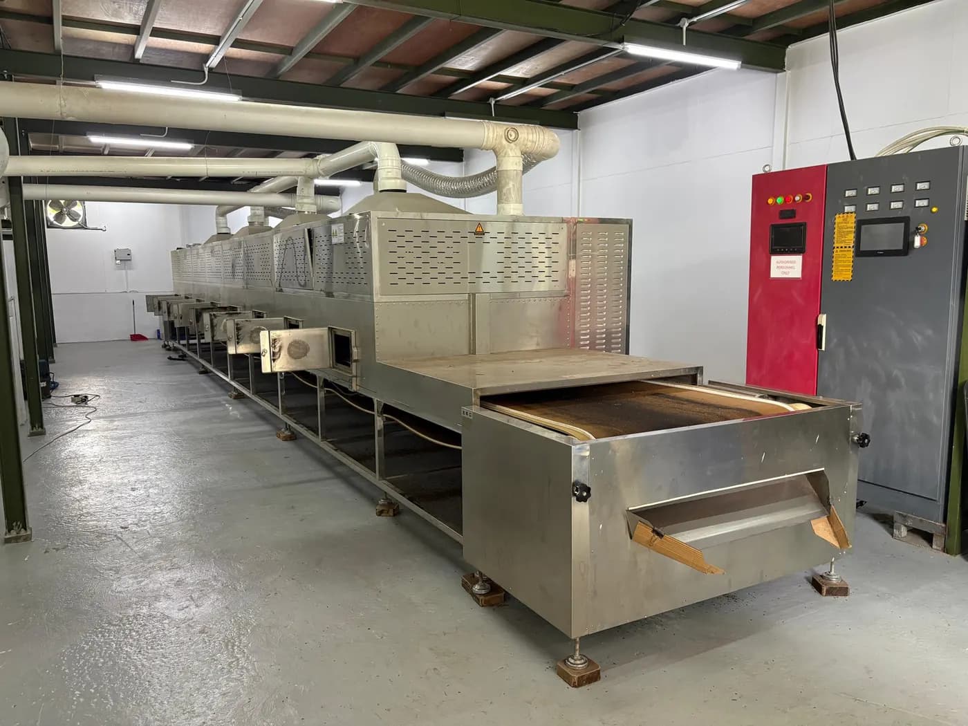 The microwave drying tunnel used to dry harvested larvae